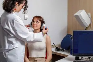 Person undergoing a professional hearing test to assess hearing sensitivity and identify potential hearing loss.